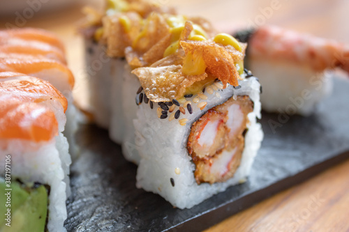 sushi roll filled with prawns, phyllo dough topping, and honey mustard