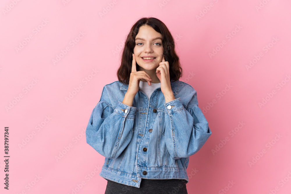 Teenager Ukrainian girl isolated on pink background smiling with a happy and pleasant expression Teenager Ukrainian girl isolated on pink background smiling with a happy and pleasant expression