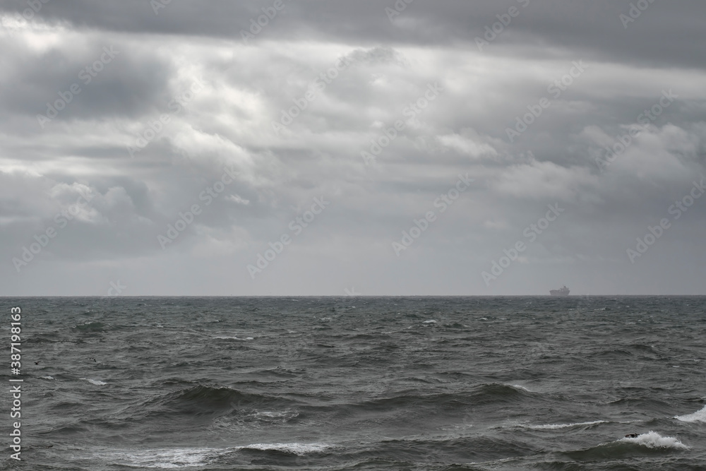 Cloudy seascape with a ship on the horizon Cloudy seascape with a ship on the horizon