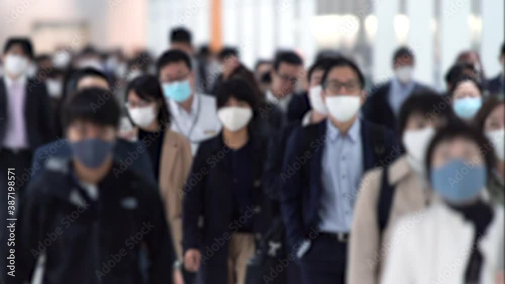 Covid-19 : Crowd of people wearing masks walking to work in Tokyo, JAPAN / slow motion