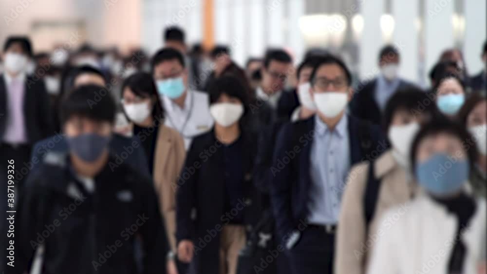 Covid-19 : Crowd of people wearing masks walking to work in Tokyo, JAPAN / slow motion