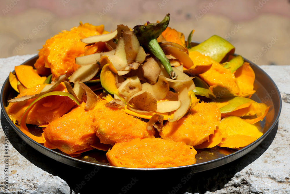 Mango and potato skin waste with seed in plate Mango and potato skin waste with seed in plate