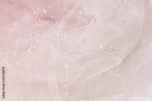  pink background made of transparent shiny fabric with pearls © pcperle