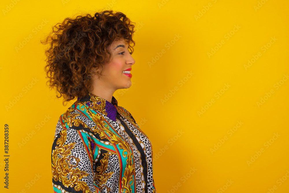 Profile of smiling woman with healthy pure skin, has contemplative expression, ready to have outdoor walk, isolated over white studio wall with copy space Profile of smiling woman with healthy pure skin, has contemplative expression, ready to have outdoor walk, isolated over white studio wall with copy space