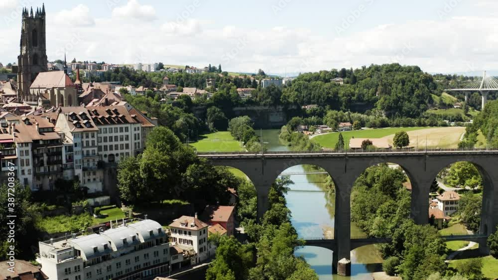 Aerial view of Fribourg town and its cathedral, Saint-Nicolas, Switzerland. Vue aérienne de la vieille ville de Fribourg filmée en drone, Suisse 4k.