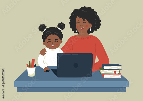 Remote learning. African mother helping child to study using laptop. Online distance education. 