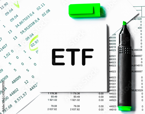 ETF note on a stack of paper with marker. Business theme photo