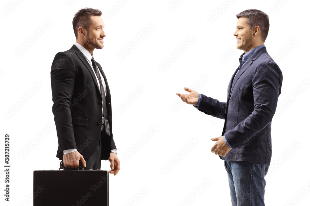 Casual man talking to a businessman with briefcase Casual man talking to a businessman with briefcase