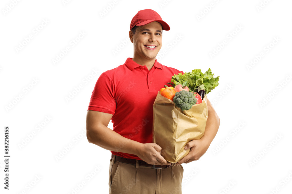 Male courier with a delivery bag of groceries smiling at camera Male courier with a delivery bag of groceries smiling at camera