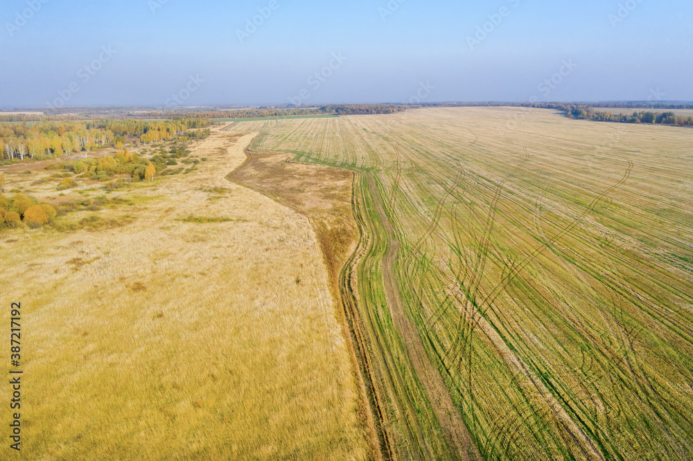 Aerial view of harvested agricultural fields on autumn day