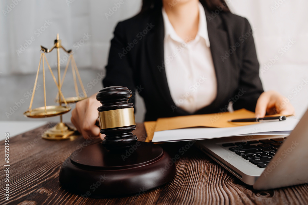 Business and lawyers discussing contract papers with brass scale on desk in office. Law, legal services, advice, justice and law concept Business and lawyers discussing contract papers with brass scale on desk in office. Law, legal services, advice, justice and law concept
