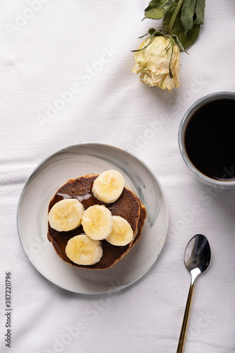breakfast in pastel: coffee with pancakes and banana
