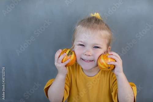 little girl with orange pumpkings photo