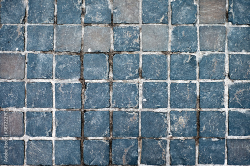 Street stone pattern. Gray cobblestones on a cloudy day.