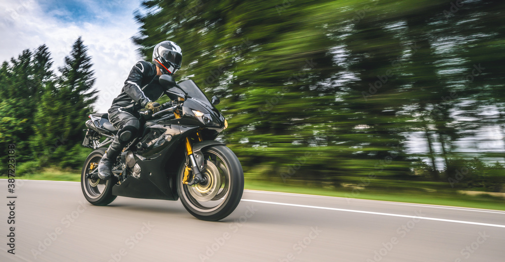 Triumph Daytona Triple Racing motorbike on the road driving fast. having fun on the empty highway Triumph Daytona Triple Racing motorbike on the road driving fast. having fun on the empty highway