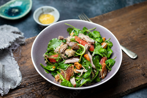 Salad with pulled duck, cashew nuts and grapefruit