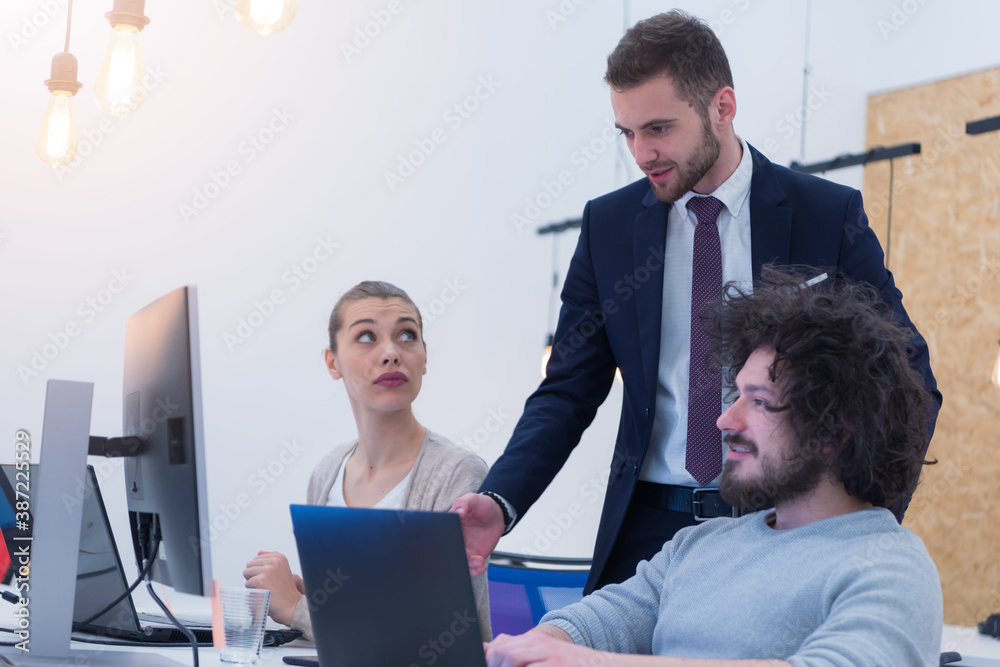 Group of coworkers having a business plan presentation at their office Group of coworkers having a business plan presentation at their office