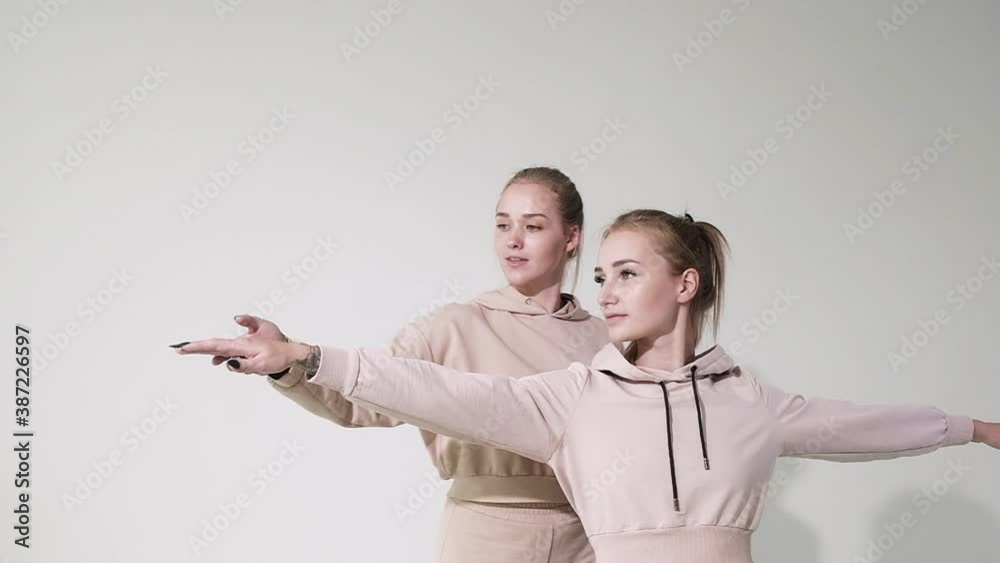 Cute Girl doing fitness in white Studio. young female instructor helps you perform yoga exercises correctly strengthen your body muscles lead healthy lifestyle. Fitness exercises with home instructor Cute Girl doing fitness in white Studio. young female instructor helps you perform yoga exercises correctly strengthen your body muscles lead healthy lifestyle. Fitness exercises with home instructor