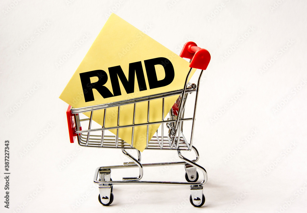 Shopping cart and text RMD on yellow paper note list. Shopping list, business concept on white background.