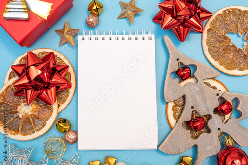 Christmas composition. Gifts and fur tree on blue background. Top view copy space. Nature New Year concept