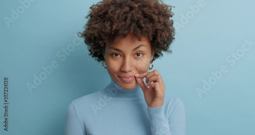 Young African American girl tells secret to trustworthy person keeps lips shut as zip asks to keep information confidential gives taboo to talking swears not to tell what happened photo