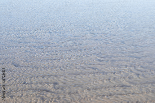 Textures made by water and wind on the sand at the beach