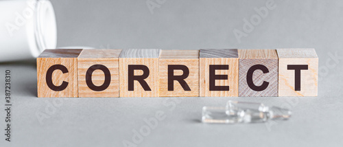 Correct is a word written in black letters on wooden cubes.