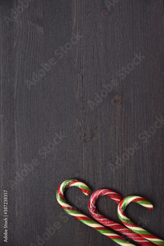 Christmas lollipops on a wooden background. Sweet treat for children and adults on holidayChristmas lollipops on a wooden background. Sweet treat for children and adults on holiday photo