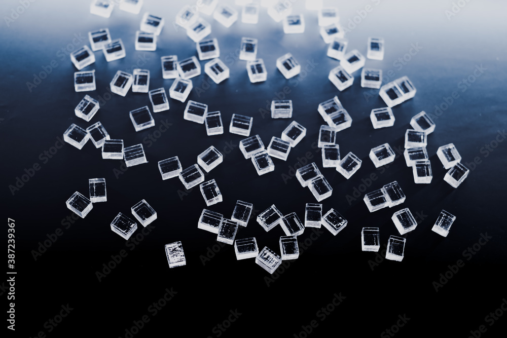 abstract plastic parallelepipedic shapes on a dark background