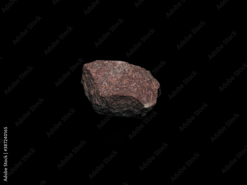 Fototapeta premium sample of crimson quartzite on a black background