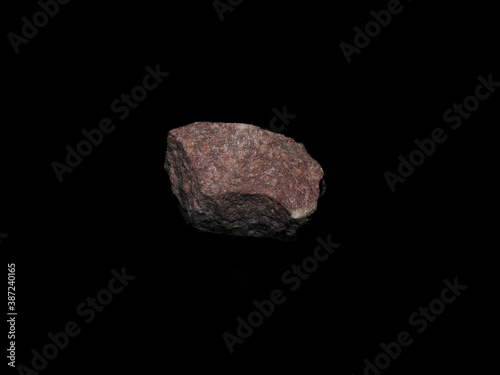 sample of crimson quartzite on a black background © Nadezhda