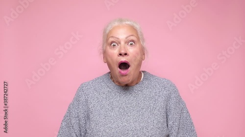 Senior hispanic woman being amazed with opened mouth because of surprise