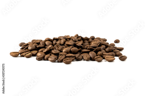 Heap of roasted coffee beans isolated on white background.