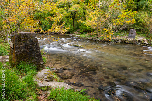 Long exposure of the river Barle flowing through the Barle Valley at Tarr Steps in Exmoor National Park photo