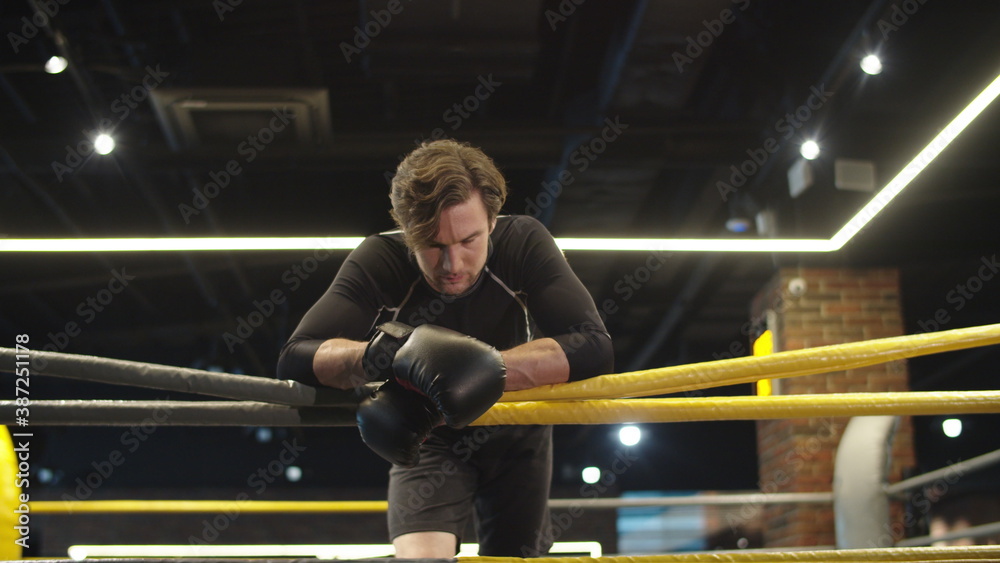 Relaxed sport man having break at gym. Fit man looking at camera in sport club Relaxed sport man having break at gym. Fit man looking at camera in sport club