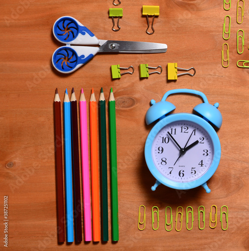 School supplies. Pencil, alarm clock, flamaster, brush, paints, paper clips, set for creativity, drawing.