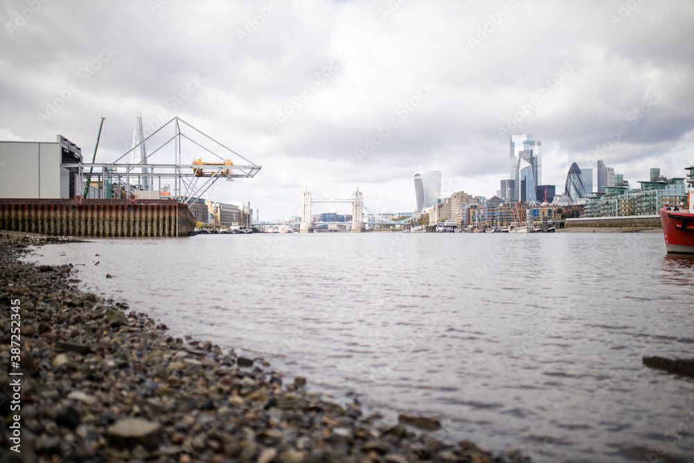 Landscape View of a Cityscape from the Rocky Ground Alongside the River Thames