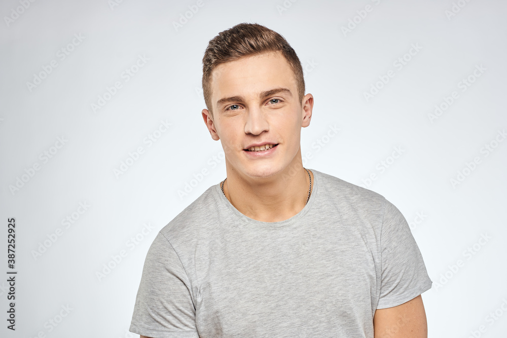 man in gray t-shirt emotions light background cropped view man in gray t-shirt emotions light background cropped view