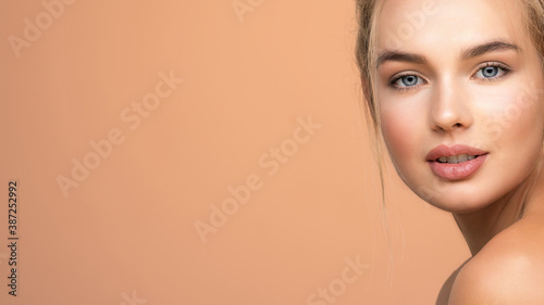 Portrait of young woman with a clean skin of the face. Blonde girl with beautiful blue eyes