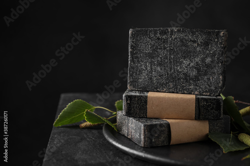 Fototapeta Naklejka Na Ścianę i Meble -  Stack of natural tar soap on black table