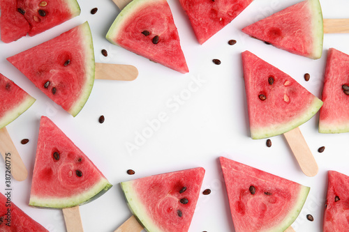 Frame made with slices of ripe watermelon on white background  flat lay. Space for text