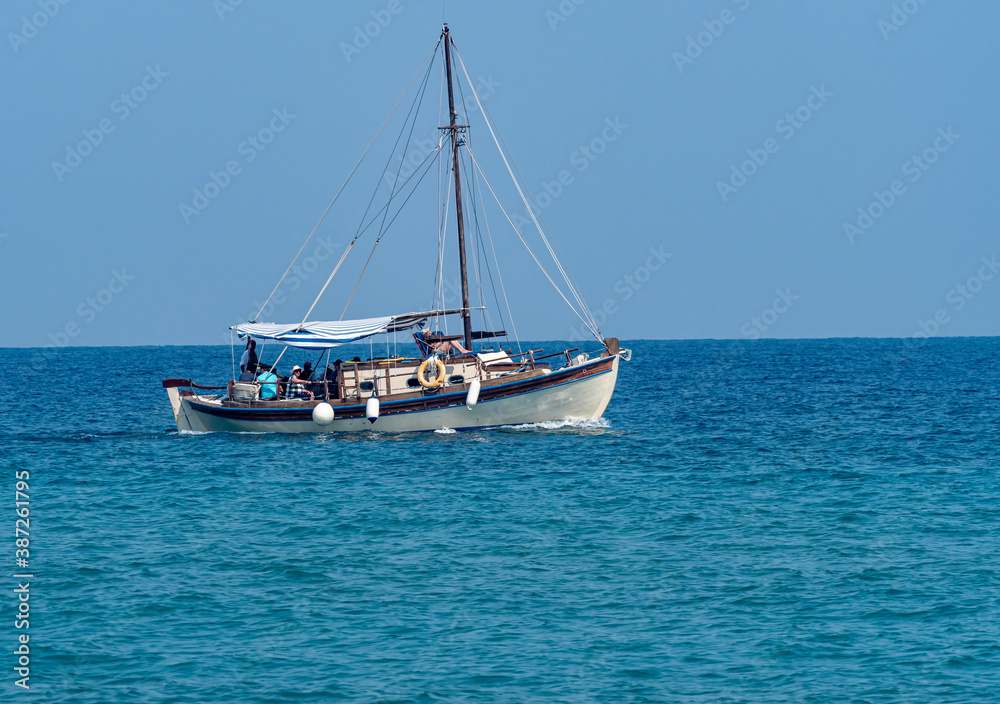 small tourist boat in blue sea small tourist boat in blue sea