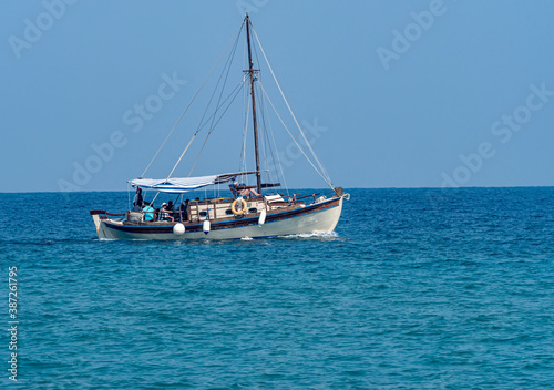 small tourist boat in blue sea