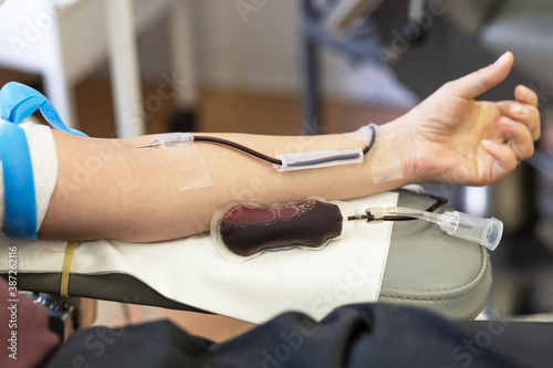 transfusion system and blood bag. donor on procedure of donation. soft focus