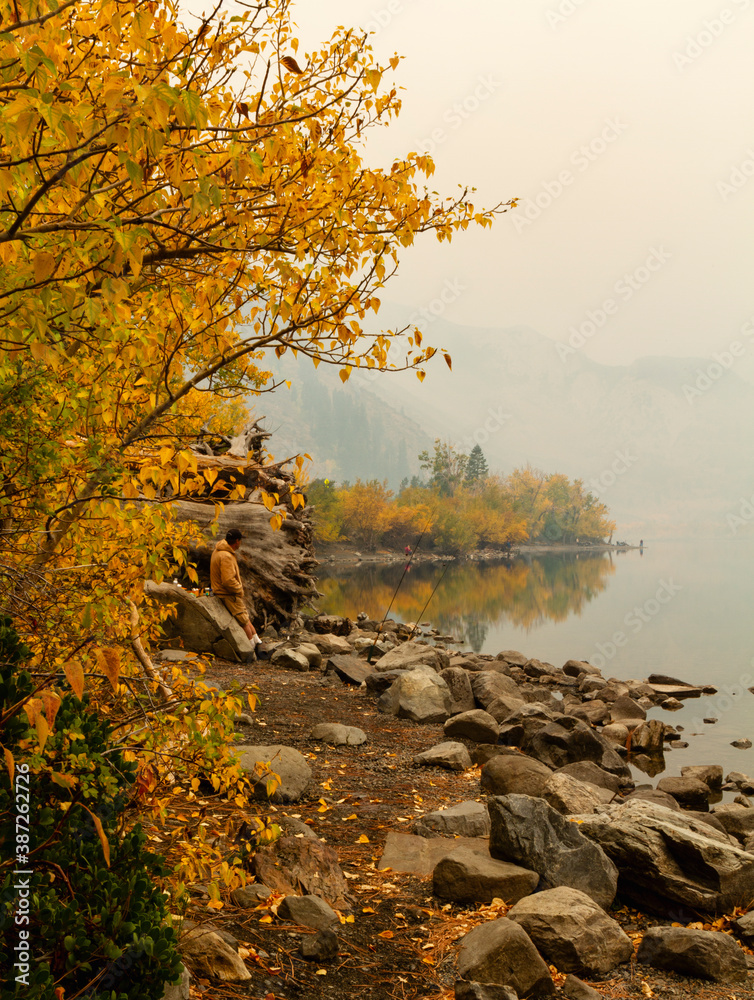 Fisherman battles the wildfire smoke in the early morning Fisherman battles the wildfire smoke in the early morning