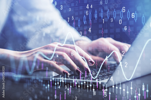 Double exposure of businesswoman hands typing on computer and forex chart hologram drawing. Financial analysis concept.