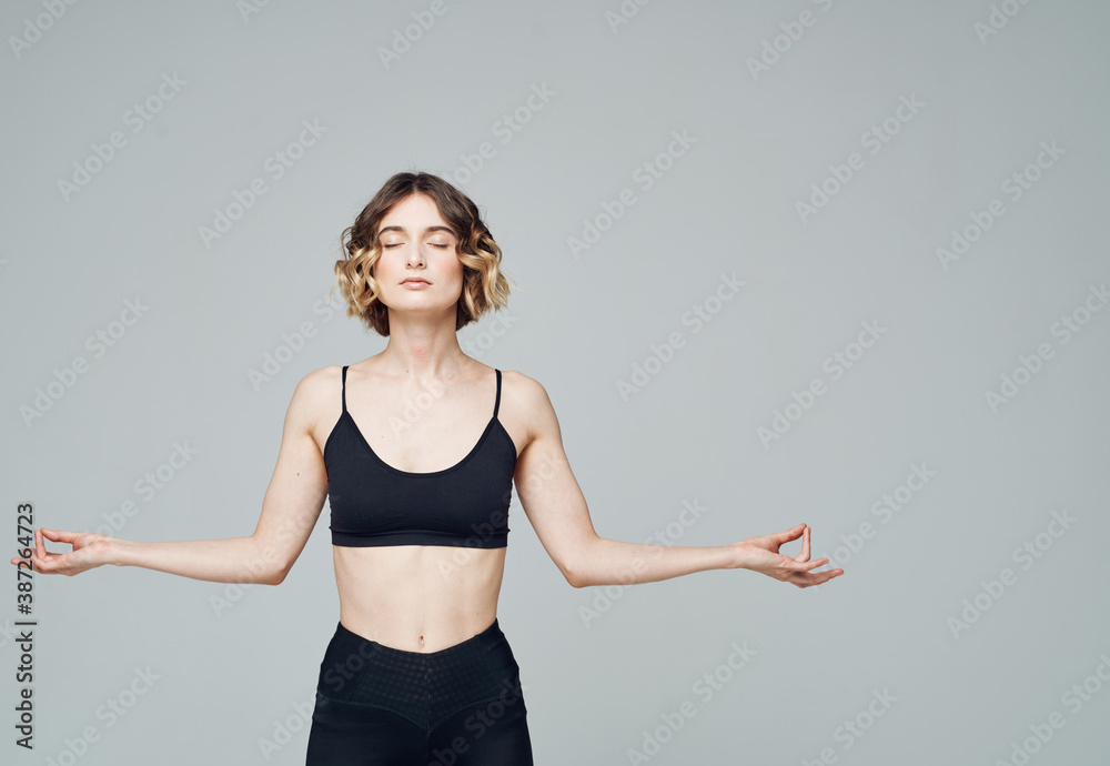 Woman in sportswear gestures with her hands on a gray background Copy Space Woman in sportswear gestures with her hands on a gray background Copy Space