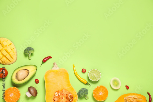 Fototapeta Naklejka Na Ścianę i Meble -  Flat lay composition with fresh organic fruits and vegetables on light green background. Space for text