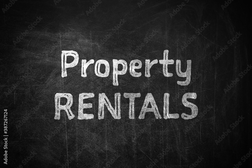 Text Property Rentals written on black chalkboard Text Property Rentals written on black chalkboard