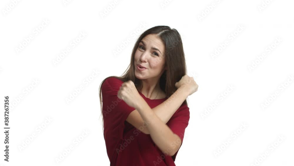 Happy brunette girl in red t-shirt cheering up, praising good work and smiling pleased, supporting great choice, standing over white background Happy brunette girl in red t-shirt cheering up, praising good work and smiling pleased, supporting great choice, standing over white background